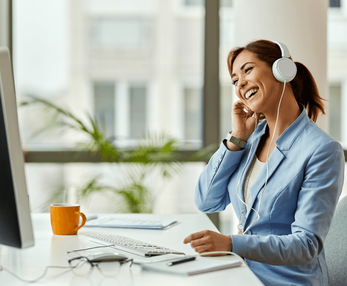 Happy woman waving at laptop during therapy session