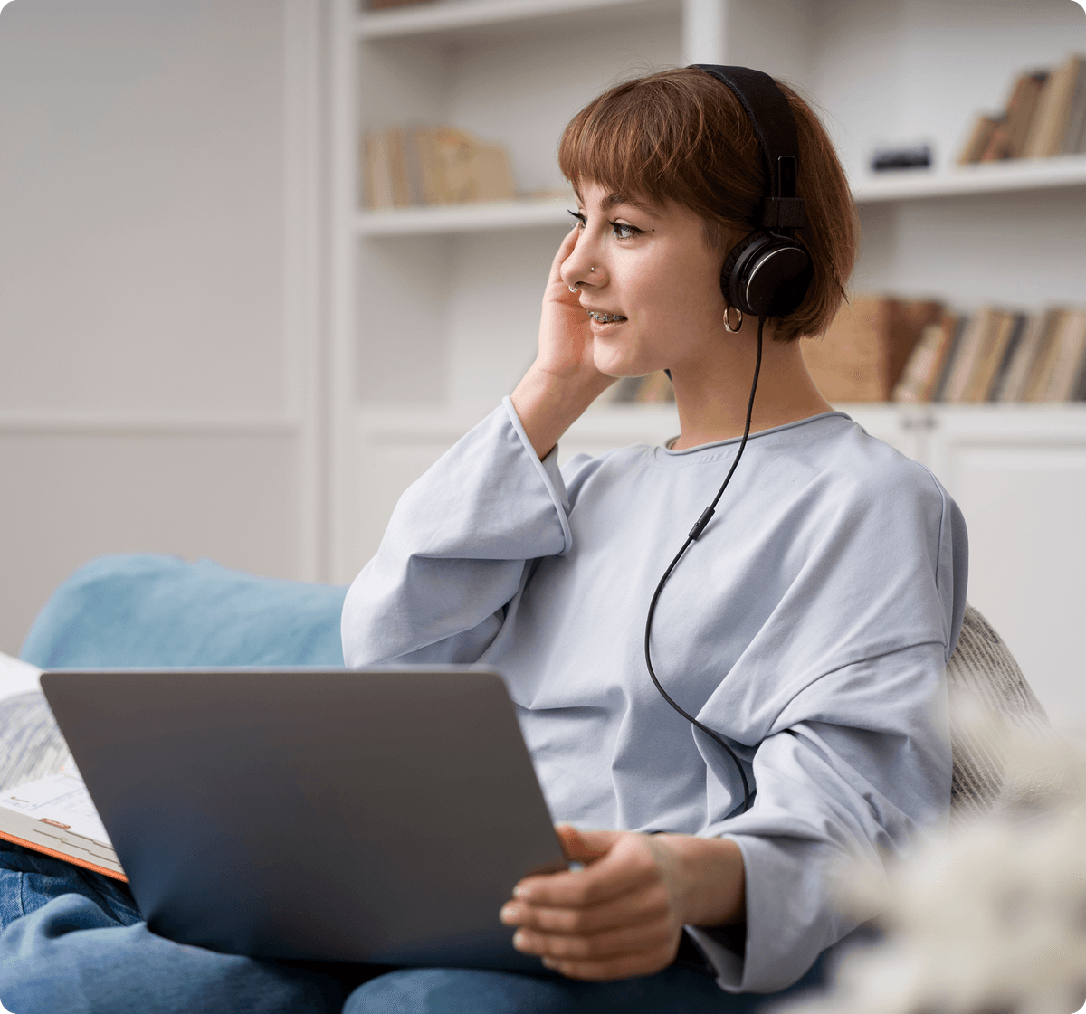Happy woman waving at laptop during therapy session