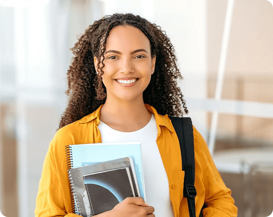 Happy student with books