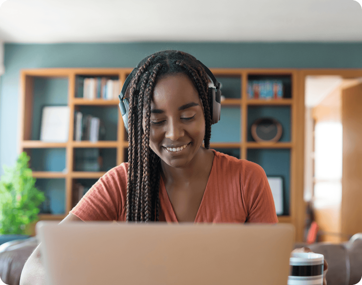 Happy woman waving at laptop during therapy session