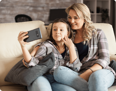 little-girl-making-funny-faces-during-video-call-smartphone-sitting-her-mother-1